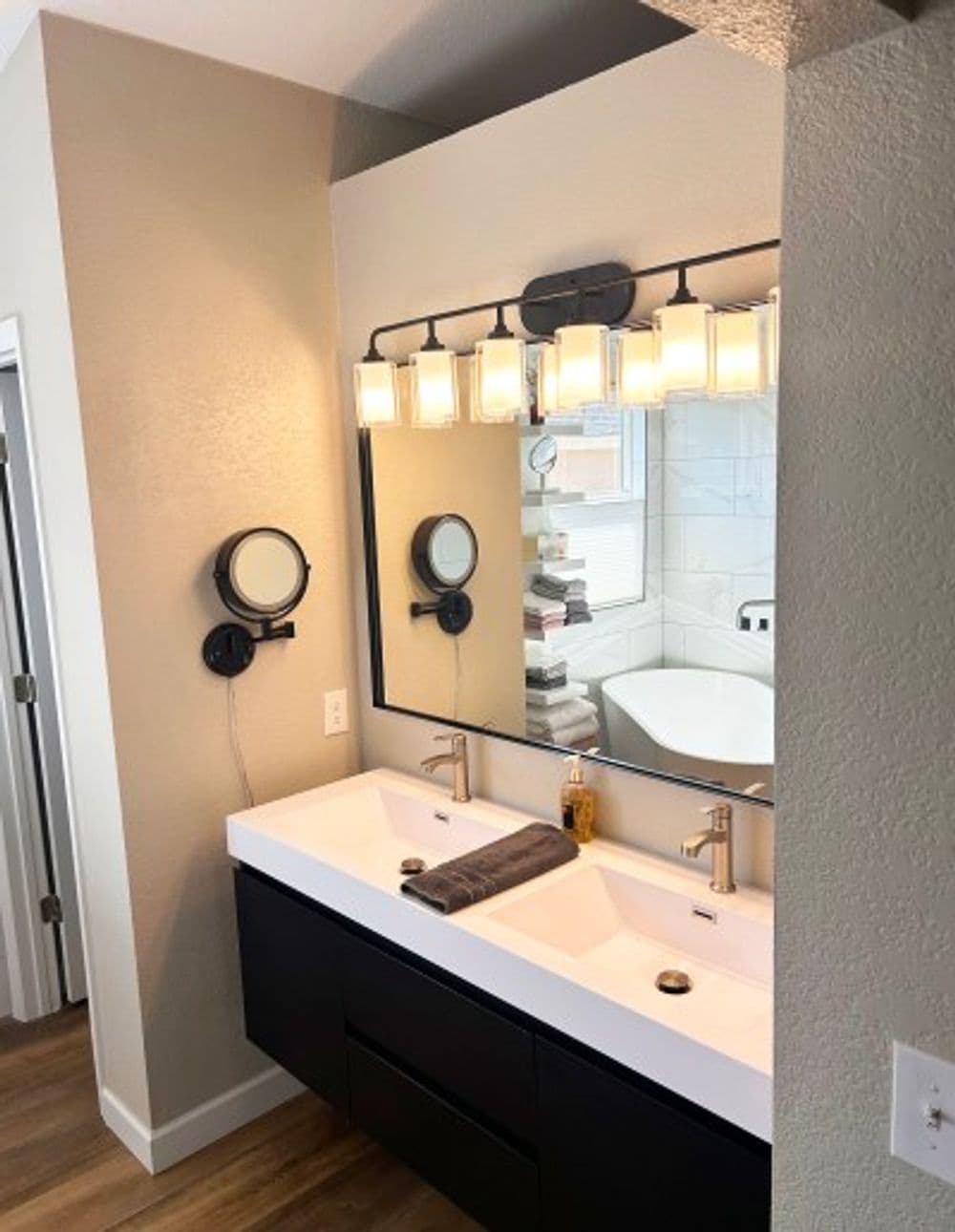 Modern bathroom with dual sinks, stylish mirror, and elegant lighting features.