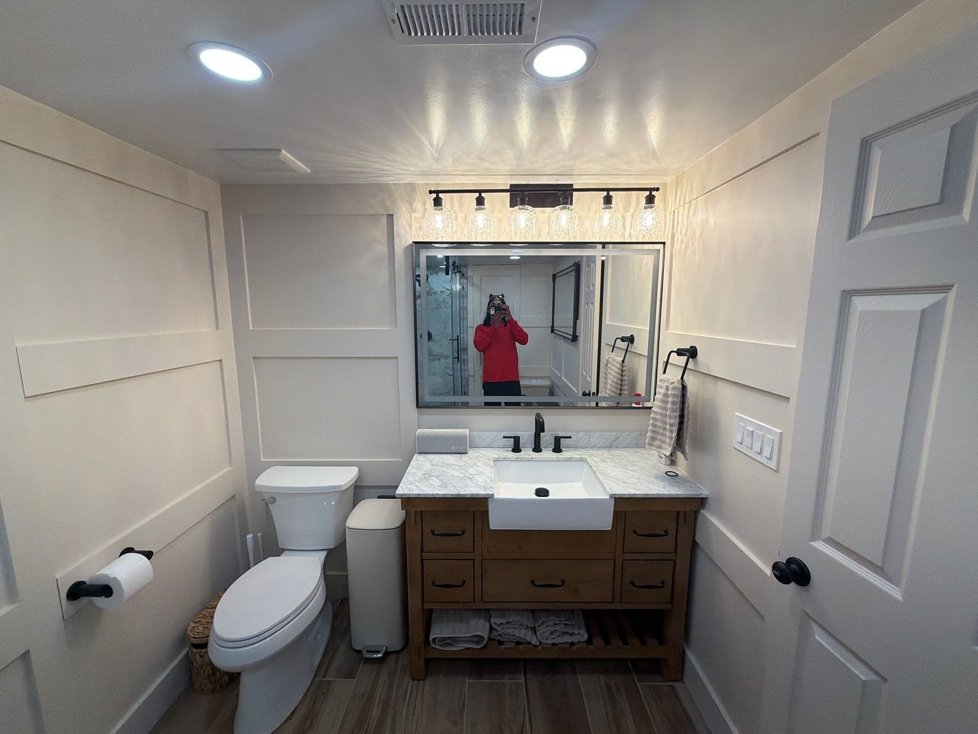 Custom Bathroom Remodel with Hidden Doors and Glass Shower image